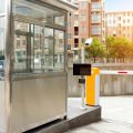 A small shelter booth guards the entrance to an underground parking lot. An automatic arm protects the area.